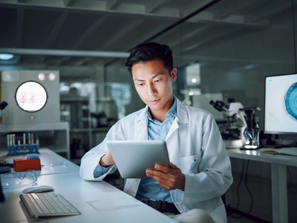 Tablet, planning and scientist with digital innovation, data and reading in laboratory